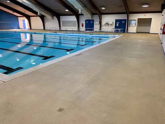 Norfolk, VA indoor pool deck knock down Thin-finish and ccs with stenciled depth markers by Distinguished Designs Decorative Concrete Coatings and Epoxy Floors @ddconcrete.net - 1