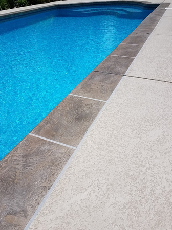 Pool spray texture with hand troweled tile border by Customcrete, Inc. @customcrete - 2
