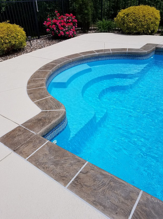 Pool spray texture with hand troweled tile border by Customcrete, Inc. @customcrete - 1