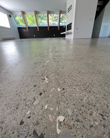 Commercial space using a polymer modified cement mortar to camouflage the cracks and then procceded to an 80-grit, finish with WCS EMULSION™ by Idaho Artistic Concrete, LLC 2